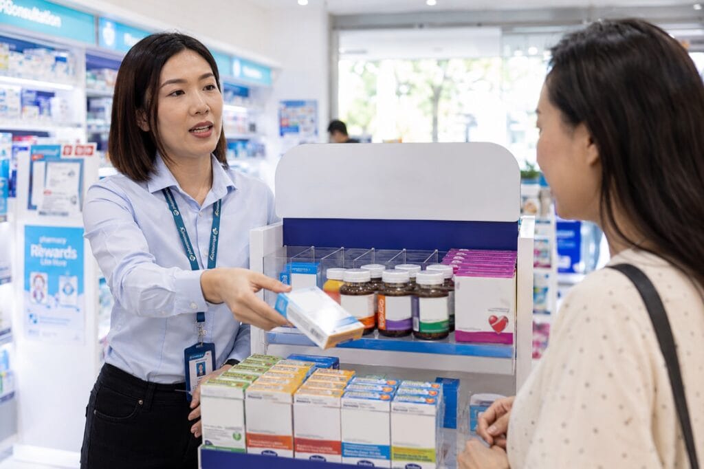 Prioocare Product Specialist Running An In-Store Brand Activation And Product Sampling At A Malaysian Pharmacy